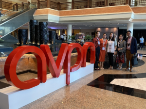 Team group photo of five Pearl Consulting team members standing beside the AVPN logo.